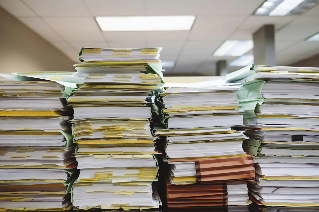 A desk stacked full of paperwork