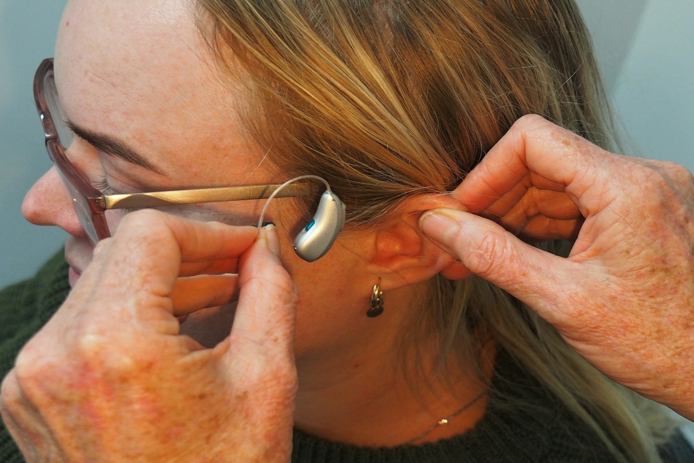A woman being fitted with a hearing aid